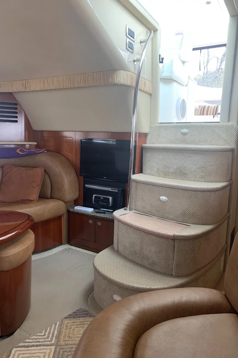 Slide: The Image of Interior of 2005 Sea Ray 390 Motor Yacht with cozy seating and carpeted stairs. - 35
