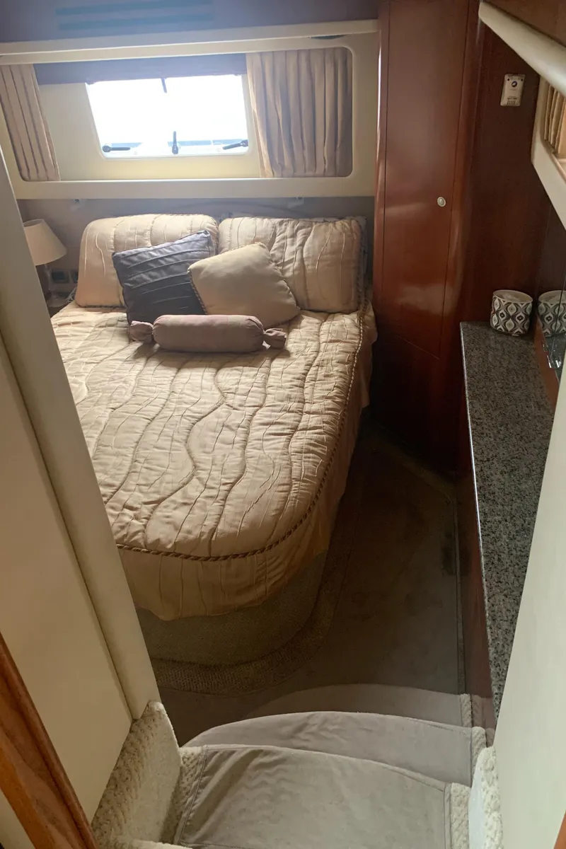 Slide: The Image of 2005 Sea Ray 390 Motor Yacht bedroom with cozy bed and window view. - 38