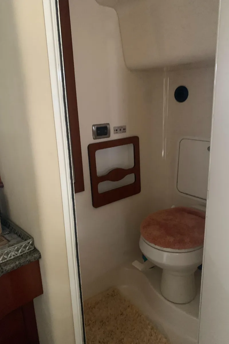 Slide: The Image of 2005 Sea Ray 390 Motor Yacht bathroom with toilet and storage. - 40