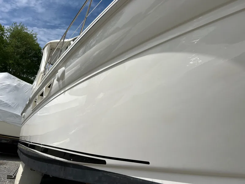 Slide: The Image of 2005 Sea Ray 390 Motor Yacht side view, white hull, docked outdoors. - 6