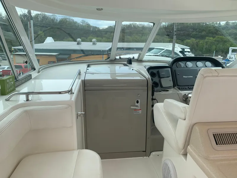 Slide: The Image of 2005 Sea Ray 390 Motor Yacht helm with navigation equipment and white seating. - 8