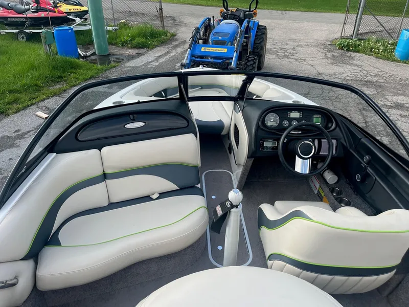 Slide: The Image of 2014 Malibu Response TXi boat interior with white and green seating. - 10