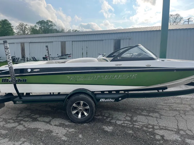 Slide: The Image of 2014 Malibu Response TXi boat on trailer, green and white, side view. - 5