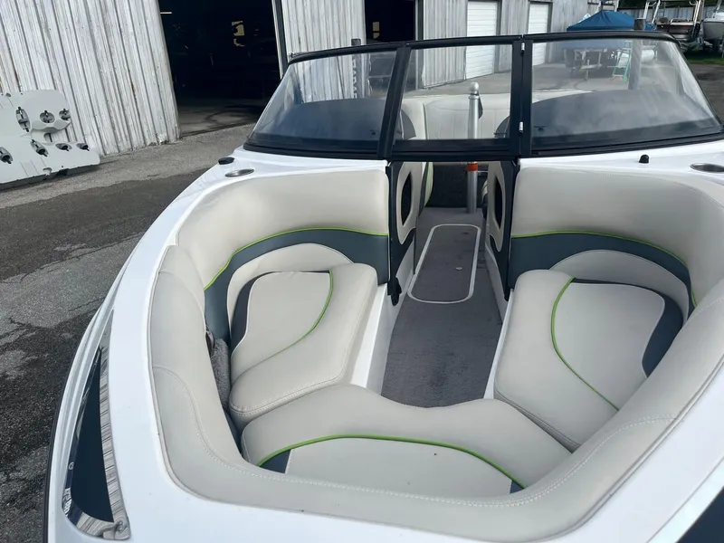 Slide: The Image of 2014 Malibu Response TXi boat with white and green interior. - 7