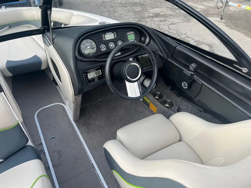 Slide: The Image of 2014 Malibu Response TXi boat interior with steering wheel and dashboard. - 8