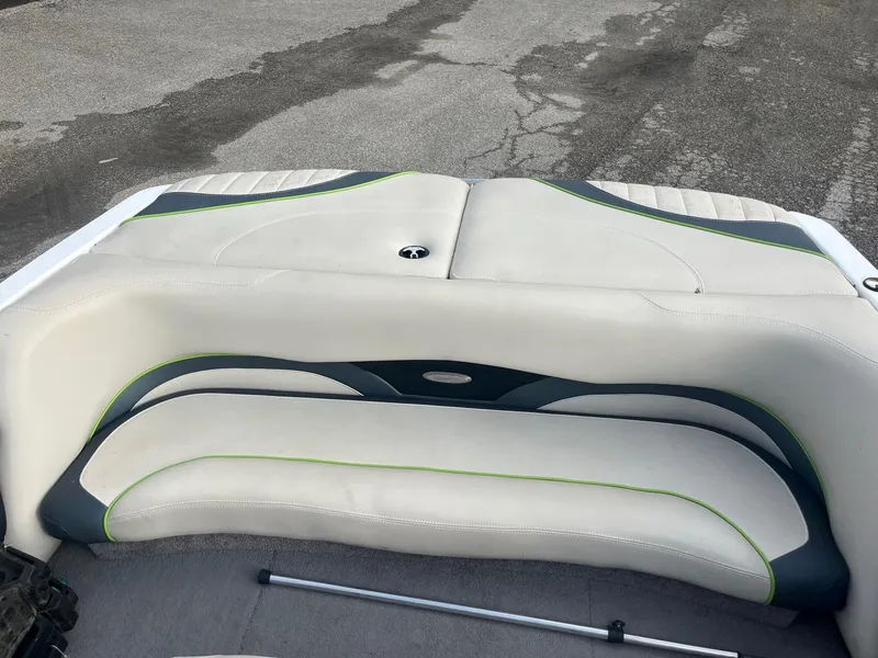 Slide: The Image of 2014 Malibu Response TXi boat interior with white and green seating. - 9