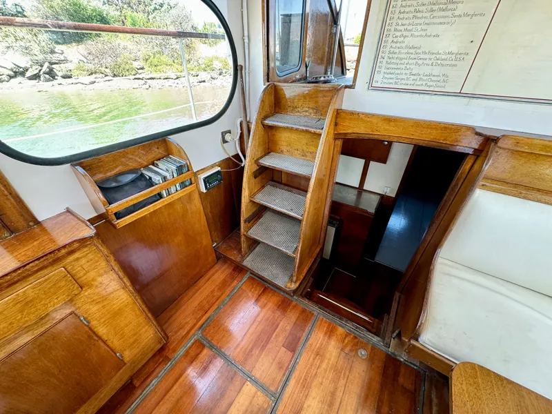 Slide: The Image of Interior of a 1966 Rampart 48 boat with bunk beds and a small sink. - 15