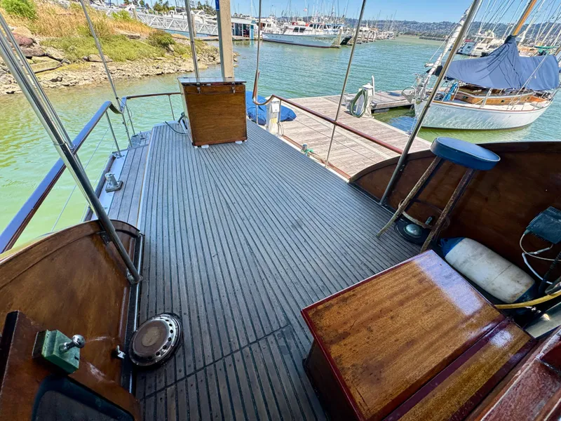 Slide: The Image of Interior of a 1966 Rampart 48 boat with wooden flooring and stairs. - 16