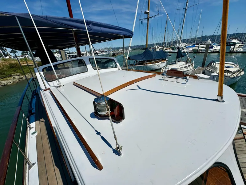 Slide: The Image of Wooden deck of 1966 Rampart 48 boat with a skylight and dock view. - 21