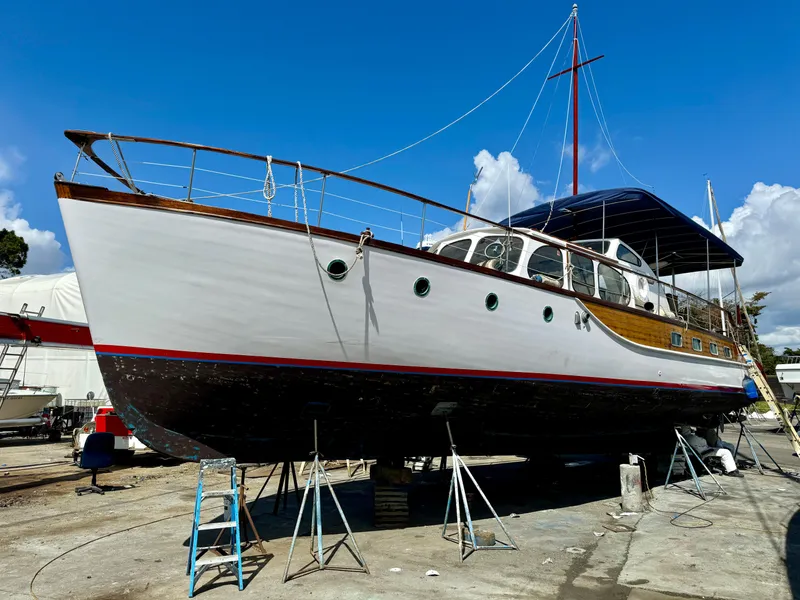 Slide: The Image of 1966 Rampart 48 yacht on dry dock, showcasing classic design and elegant wooden details. - 24