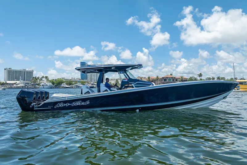 Slide: The Image of 2024 Nor-Tech 400 Supersport boat on water, clear sky, luxury waterfront background. - 11