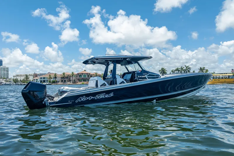 Slide: The Image of 2024 Nor-Tech 400 Supersport boat on water, clear sky background. - 13