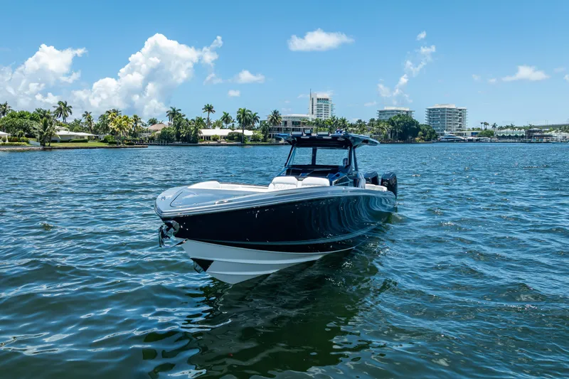 Slide: The Image of 2024 Nor-Tech 400 Supersport boat on a sunny day, with cityscape in the background. - 16