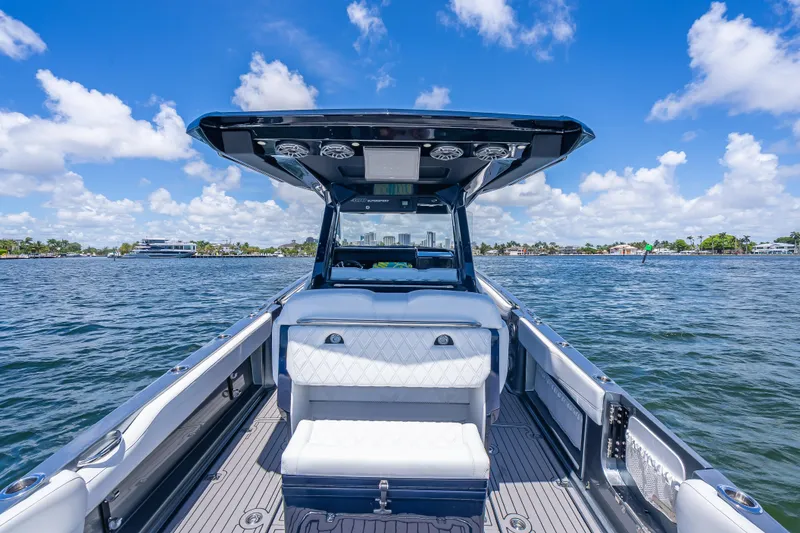 Slide: The Image of 2024 Nor-Tech 400 Supersport boat interior with luxurious seating on a sunny day. - 17