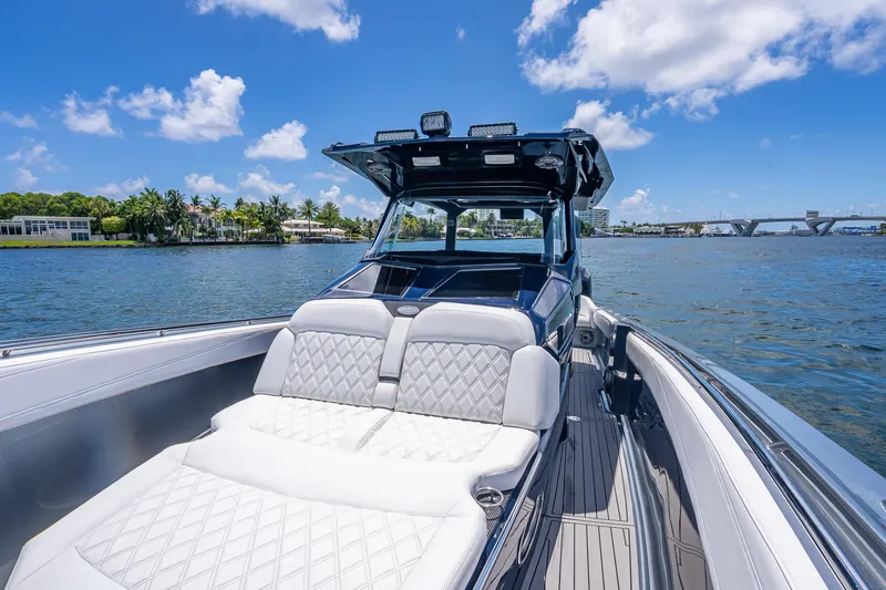 Slide: The Image of 2024 Nor-Tech 400 Supersport boat on water, featuring luxurious seating and sleek design. - 19