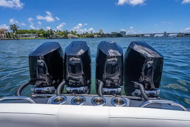Slide: The Image of 2024 Nor-Tech 400 Supersport boat with four powerful outboard engines on a sunny day. - 21