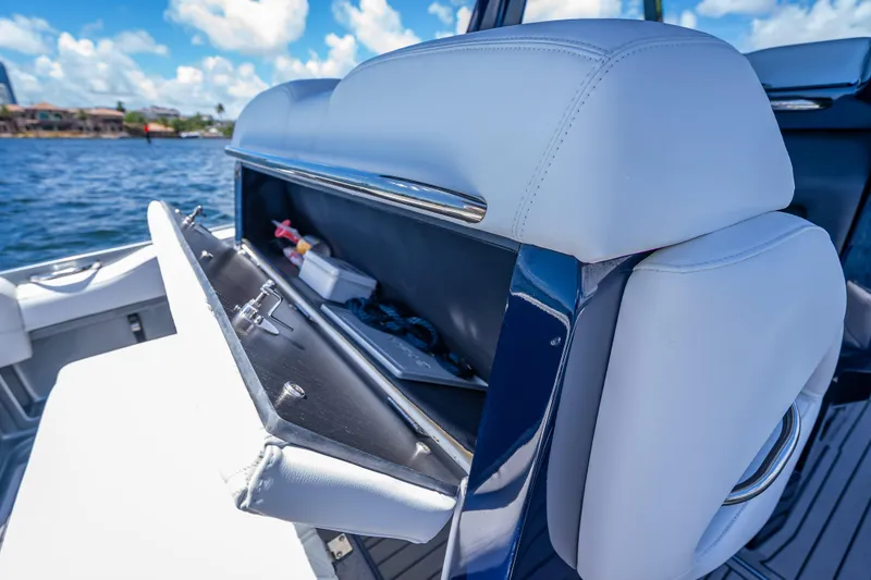 Slide: The Image of 2024 Nor-Tech 400 Supersport boat interior storage compartment with open lid, showcasing sleek design. - 28