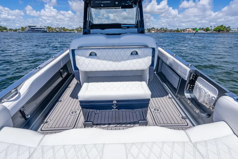 Slide: The Image of 2024 Nor-Tech 400 Supersport boat interior with luxurious seating on a sunny day. - 29