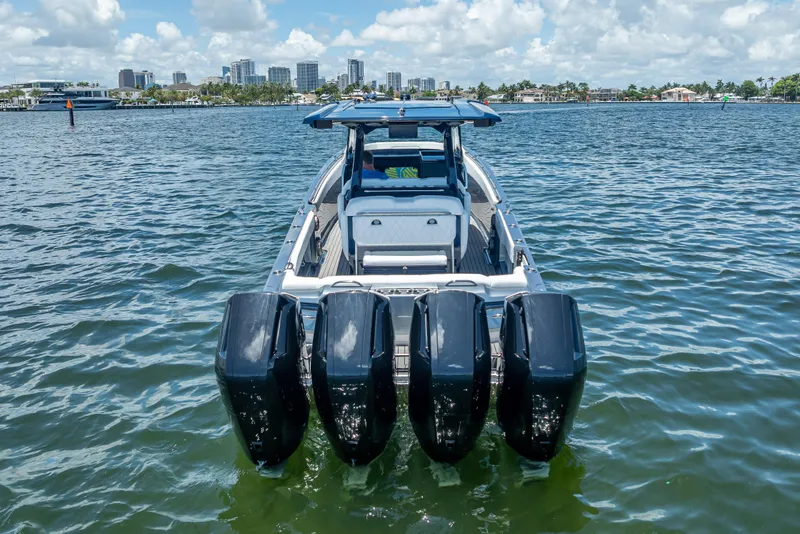Slide: The Image of 2024 Nor-Tech 400 Supersport boat with four engines on a sunny waterfront. - 3
