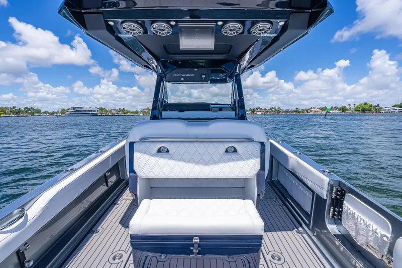 Slide: The Image of 2024 Nor-Tech 400 Supersport boat interior with luxurious seating on a sunny day. - 30