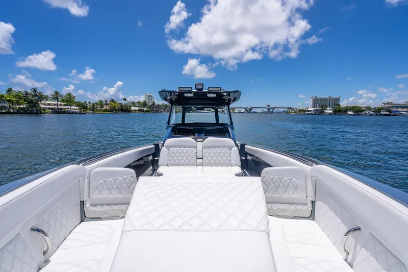 Slide: The Image of 2024 Nor-Tech 400 Supersport luxury boat on a sunny day, featuring elegant white seating. - 34