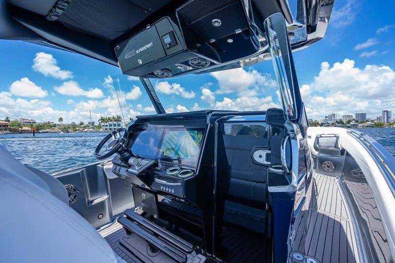Slide: The Image of 2024 Nor-Tech 400 Supersport boat interior with advanced navigation system, cruising on a sunny day. - 38