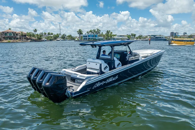 Slide: The Image of 2024 Nor-Tech 400 Supersport boat on water, featuring sleek design and powerful engines. - 4