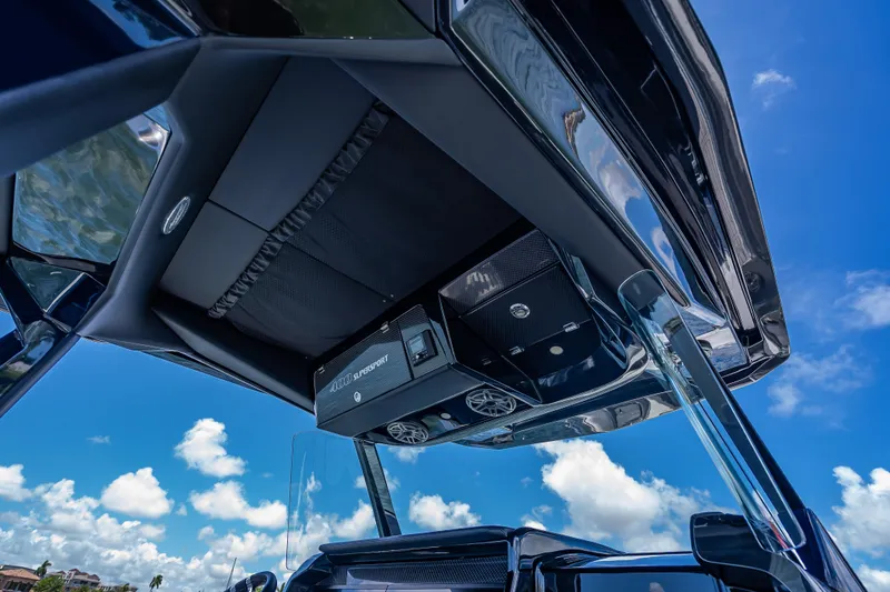 Slide: The Image of 2024 Nor-Tech 400 Supersport boat interior with sleek design and modern features under a clear blue sky. - 40