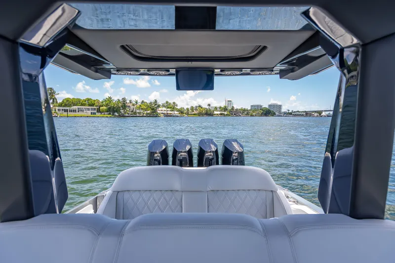 Slide: The Image of 2024 Nor-Tech 400 Supersport boat interior with quad engines on a sunny day. - 46