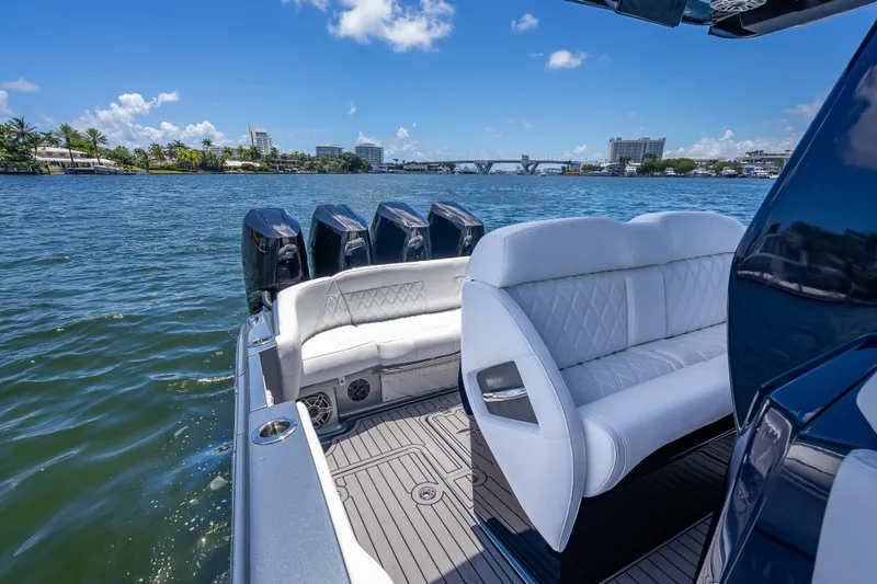 Slide: The Image of 2024 Nor-Tech 400 Supersport boat with luxurious seating on a sunny day. - 47