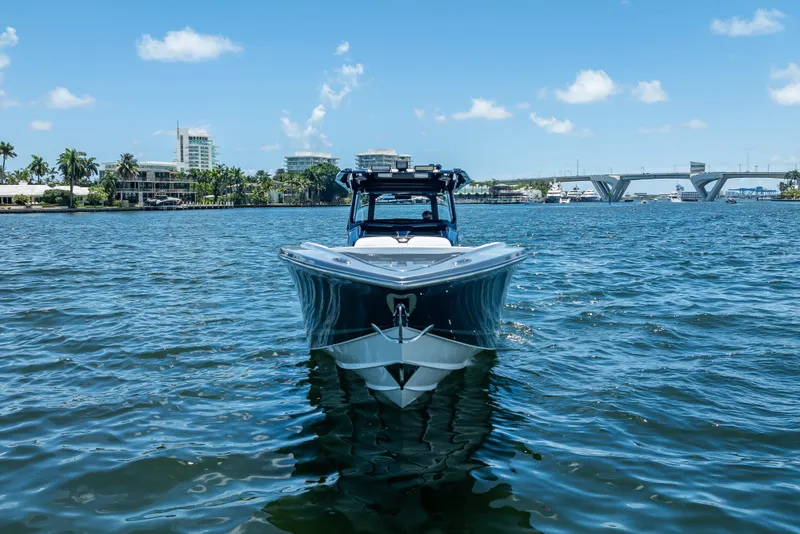 Slide: The Image of 2024 Nor-Tech 400 Supersport boat on water, cityscape and bridge in background. - 5