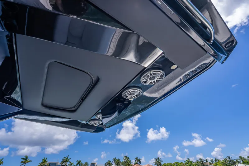 Slide: The Image of 2024 Nor-Tech 400 Supersport boat roof with speakers against blue sky. - 50