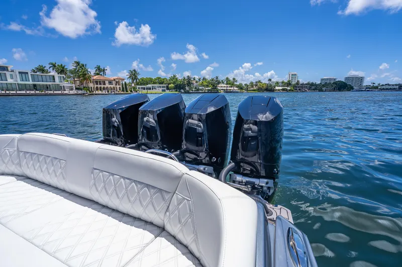 Slide: The Image of 2024 Nor-Tech 400 Supersport boat with four powerful engines on a sunny waterfront. - 51