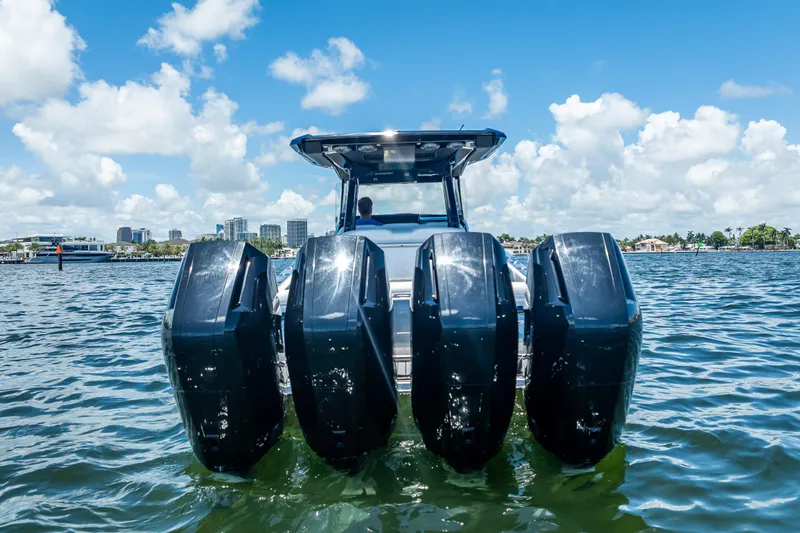 Slide: The Image of 2024 Nor-Tech 400 Supersport boat with four powerful outboard engines on the water. - 52