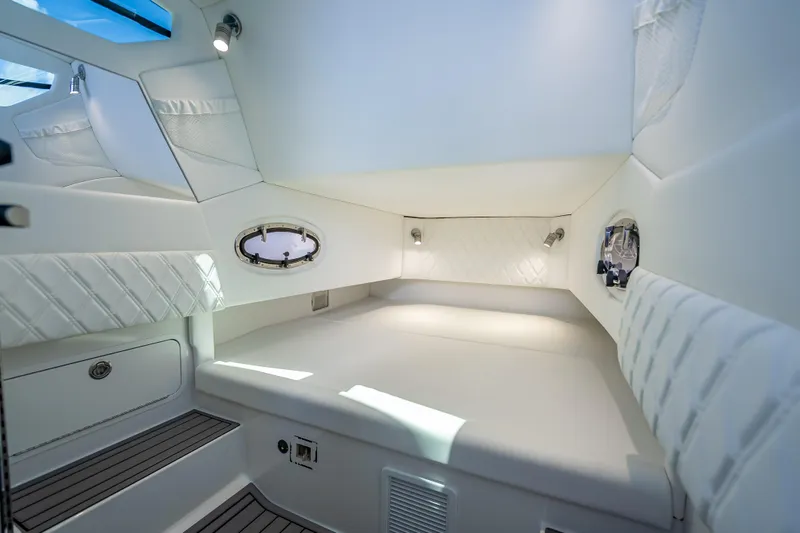 Slide: The Image of 2024 Nor-Tech 400 Supersport cabin interior with luxurious white upholstery and modern lighting. - 54