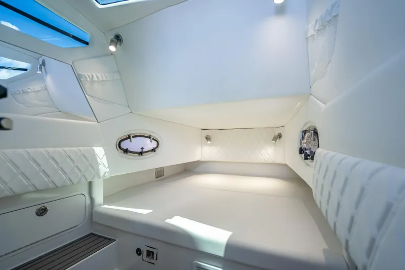 Slide: The Image of Luxurious interior cabin of 2024 Nor-Tech 400 Supersport boat, featuring elegant white upholstery. - 55