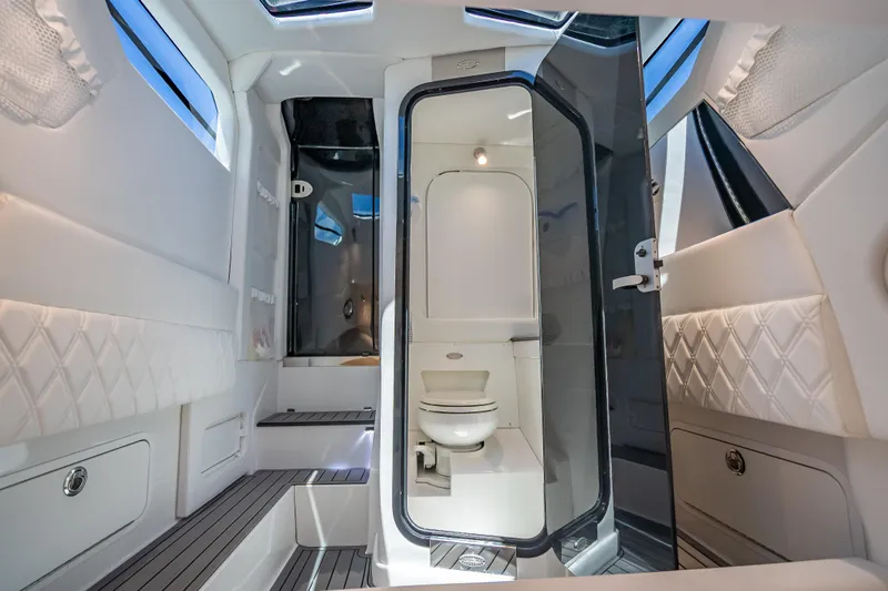 Slide: The Image of Luxurious interior of 2024 Nor-Tech 400 Supersport boat featuring modern bathroom amenities. - 58