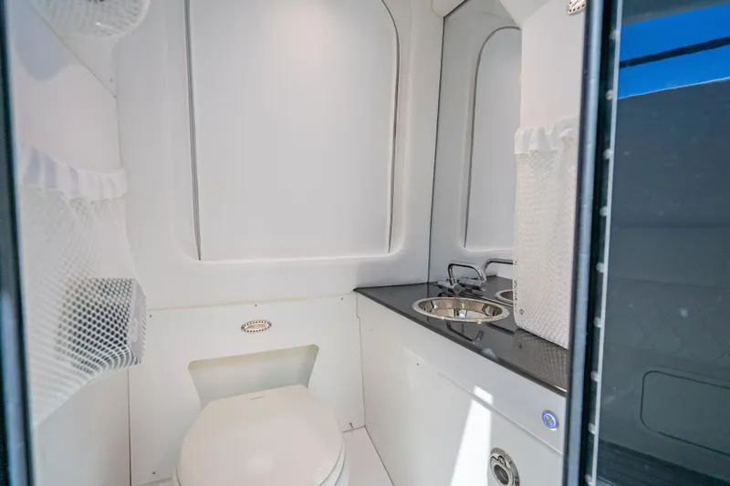 Slide: The Image of 2024 Nor-Tech 400 Supersport boat bathroom with modern sink and toilet. - 59