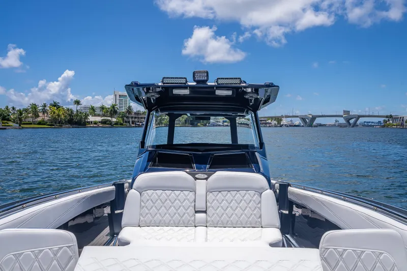 Slide: The Image of 2024 Nor-Tech 400 Supersport boat on water, featuring luxurious seating and modern design. - 61