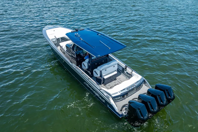 Slide: The Image of 2024 Nor-Tech 400 Supersport boat on water, featuring sleek design and powerful engines. - 8