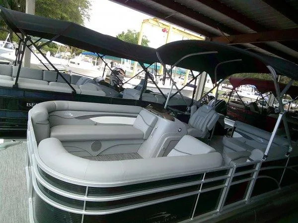 Slide: The Image of 2024 Bennington 208SLJ pontoon boat with canopy in marina. - 10