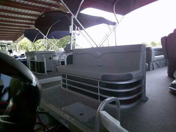 Slide: The Image of 2024 Bennington 208SLJ pontoon boat with seating under a covered dock. - 5
