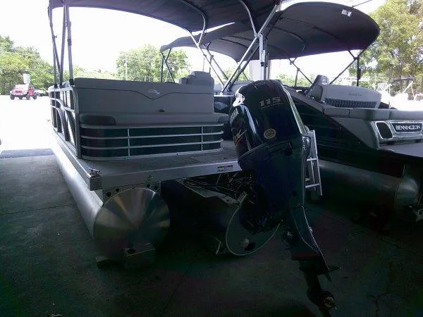 Slide: The Image of 2024 Bennington 208SLJ pontoon boat with outboard motor in a showroom. - 7