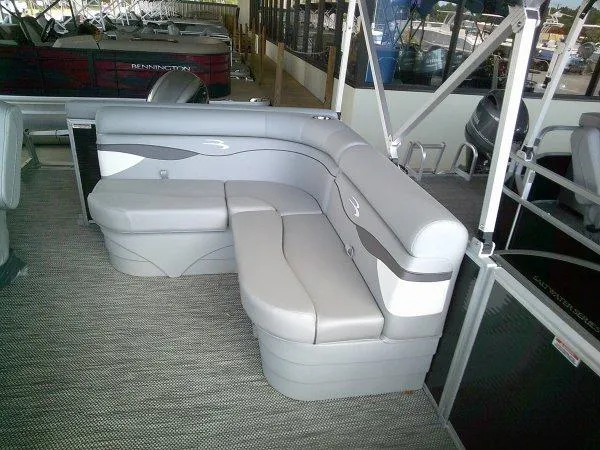 Slide: The Image of 2024 Bennington 208SLJ pontoon boat interior with gray and beige seating. - 8