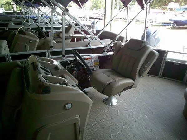 Slide: The Image of 2024 Bennington 21SXL pontoon boat interior with captain's chair and helm. - 3