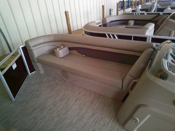 Slide: The Image of 2024 Bennington 21SXL pontoon boat interior with beige seating. - 4