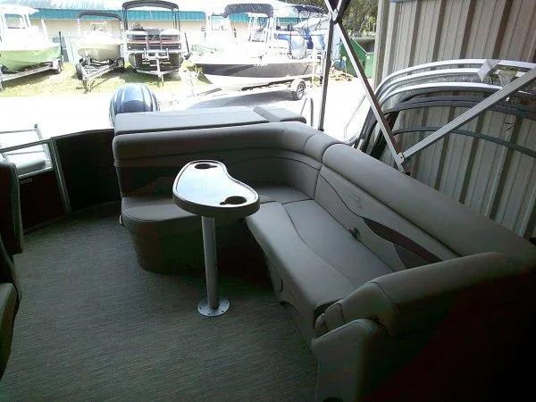 Slide: The Image of 2024 Bennington 21SXL pontoon boat interior with plush seating and table. - 5