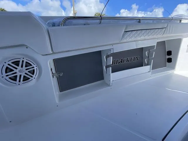 Slide: The Image of 2023 Blackfin 302CC boat interior with storage compartments and speaker. - 15