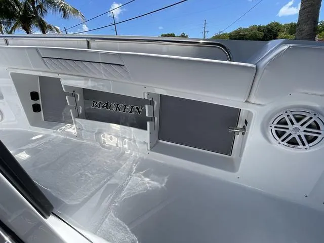 Slide: The Image of 2023 Blackfin 302CC boat interior with storage compartments and speaker. - 17