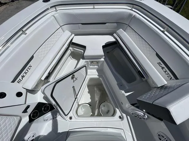 Slide: The Image of 2023 Blackfin 302CC boat interior with open storage compartments and seating. - 24